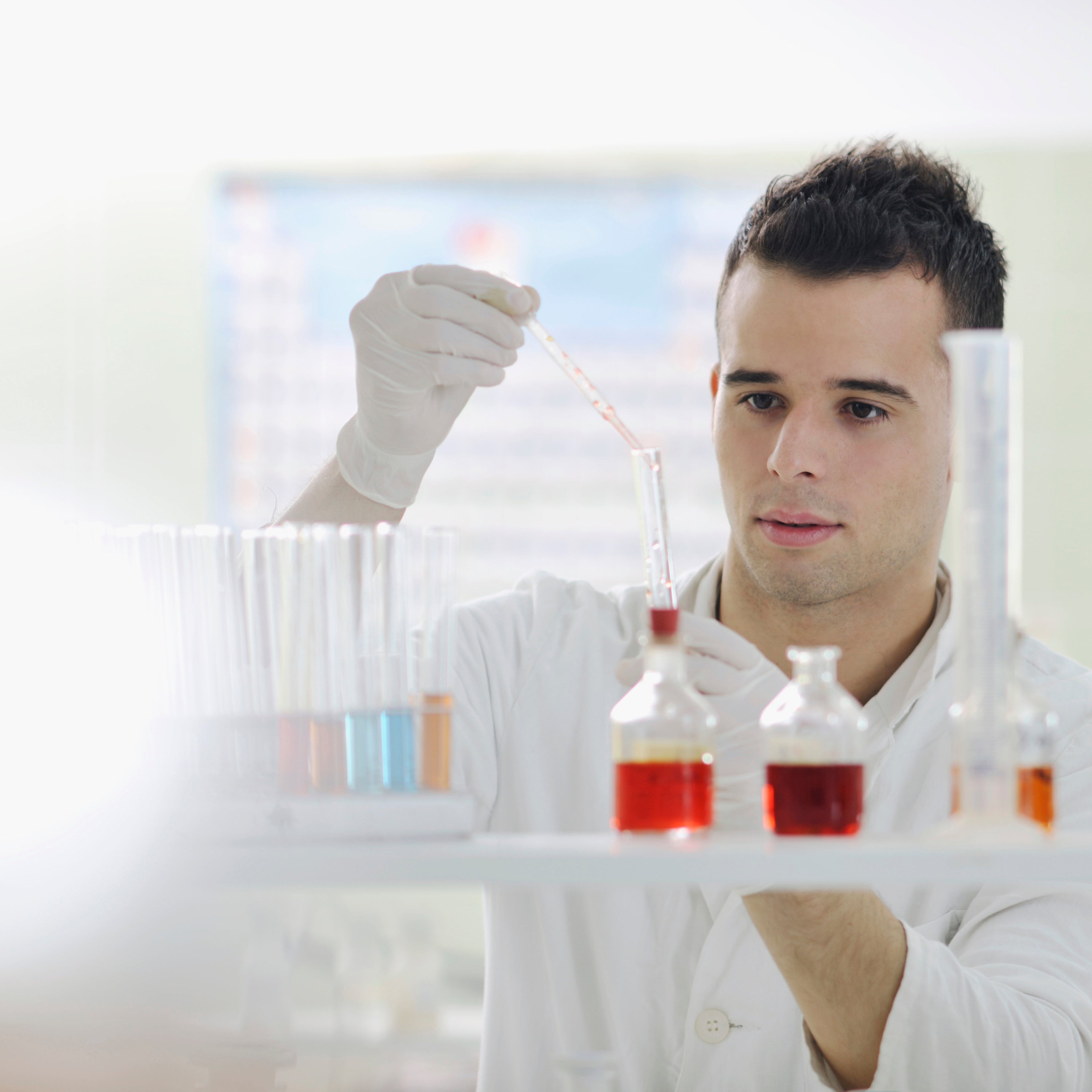 Person in a lab coat holding a test tube with red liquid gaia naturelle collagen shot